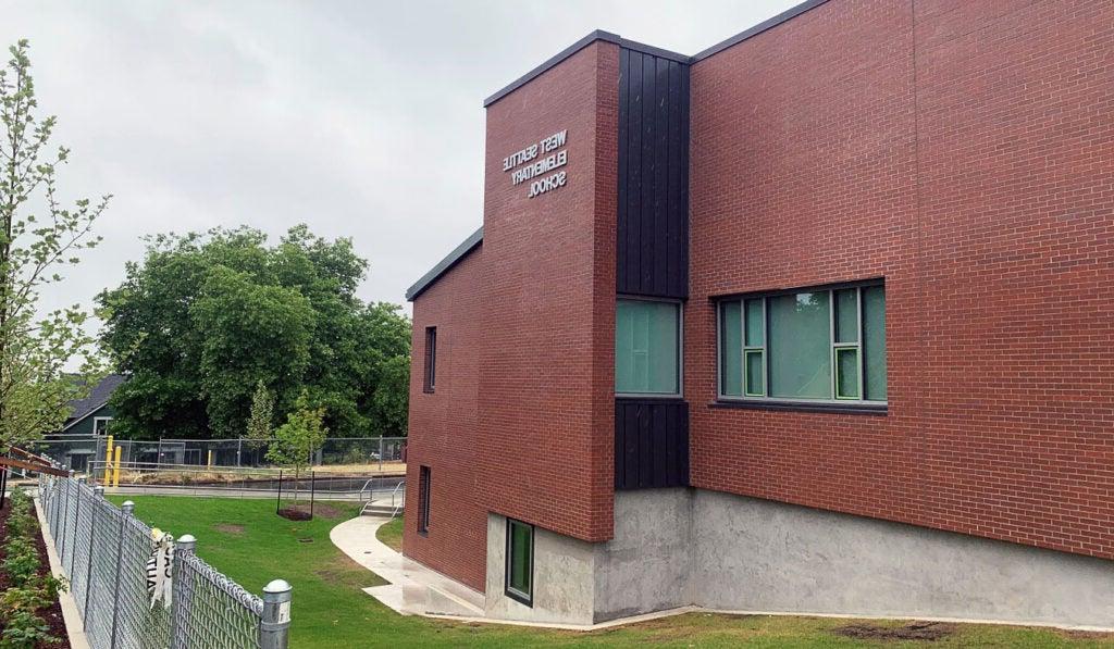 a brick building has a sign that says West Seattle Elementary School